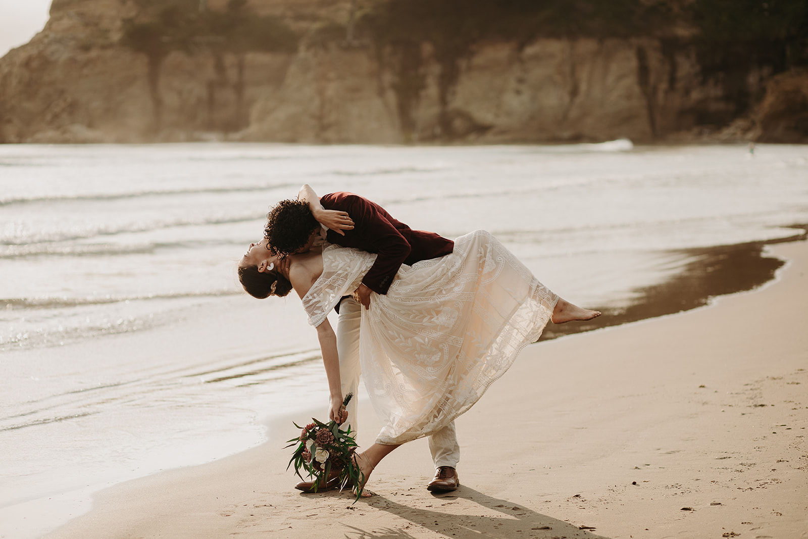 Bride and groom kissing on the beach on the Oregon Coast