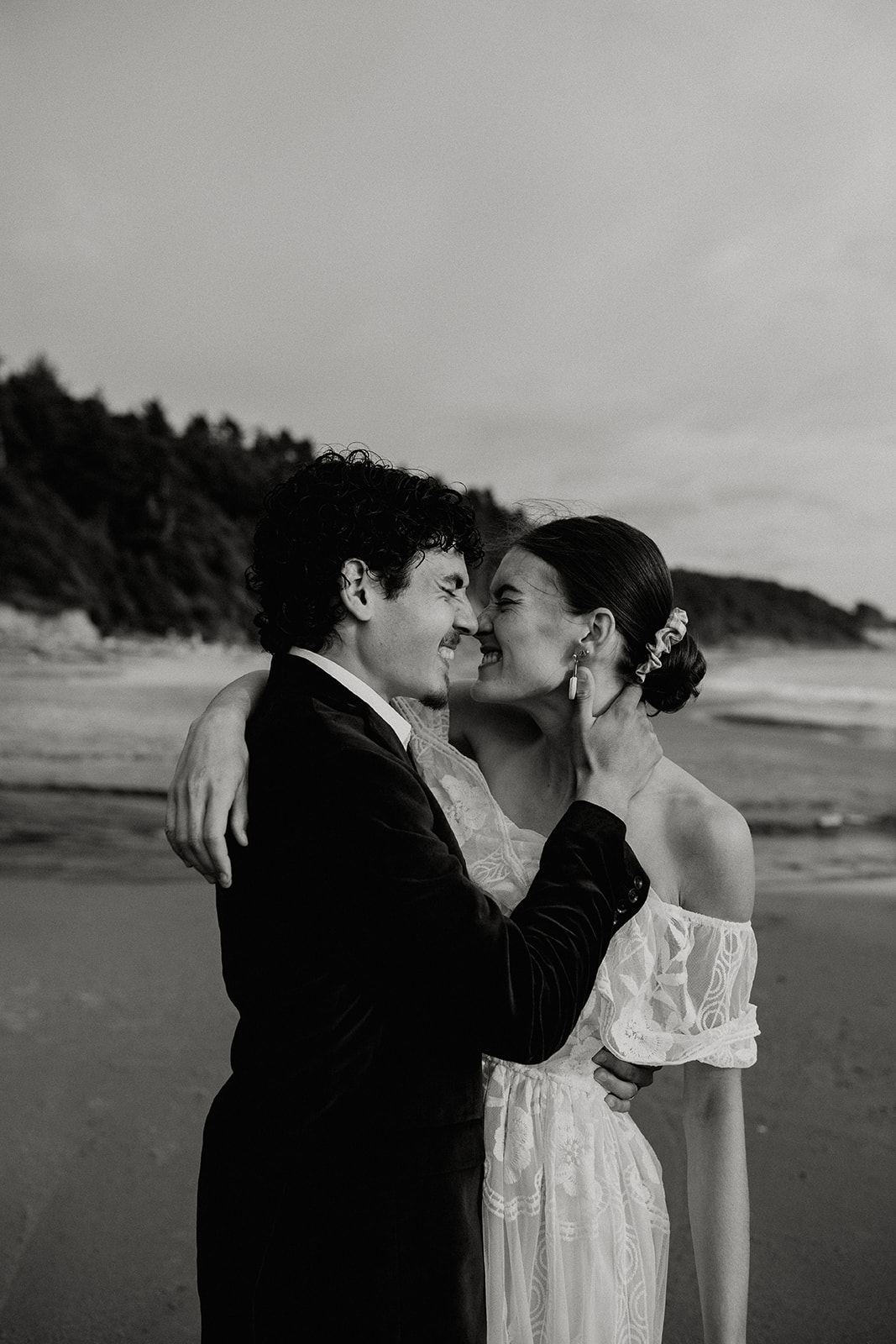 Bride and groom kissing on the beach on the Oregon Coast