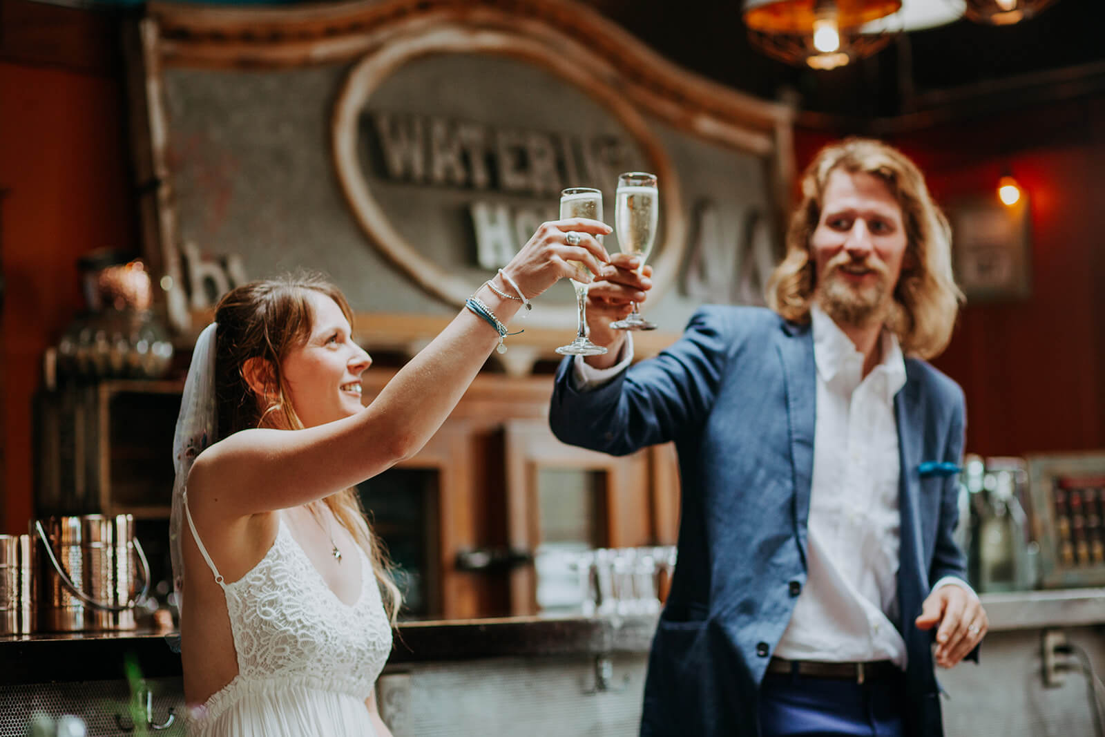 Bride and groom toast champagne during microwedding reception at Hoptown Wood-Fired Pizza