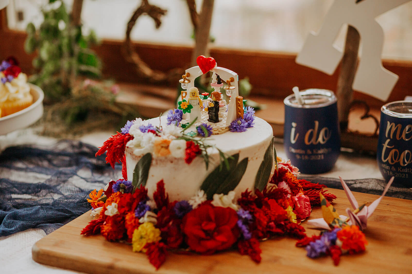 White wedding cake with red and purple flowers
