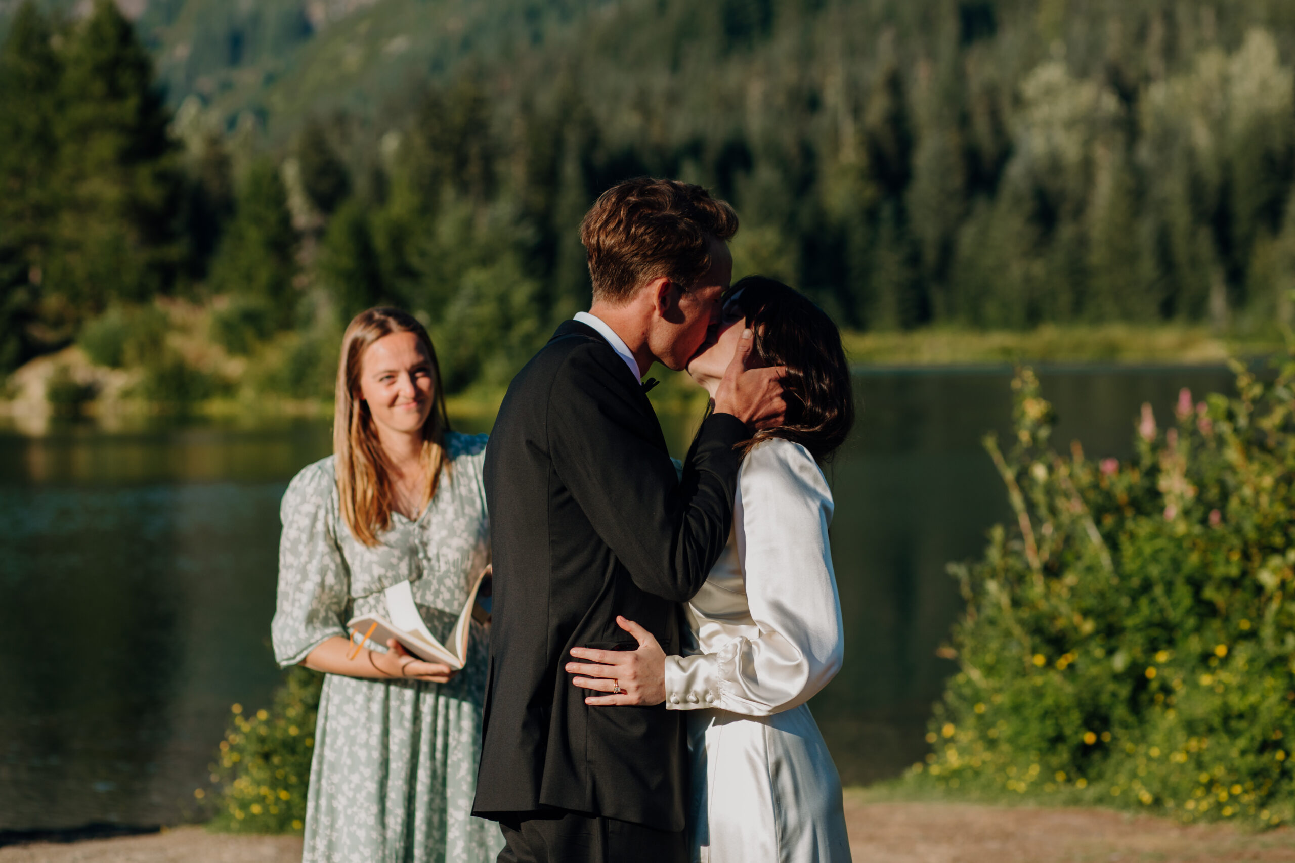 Bride and Groom kiss at Gold Creek pond