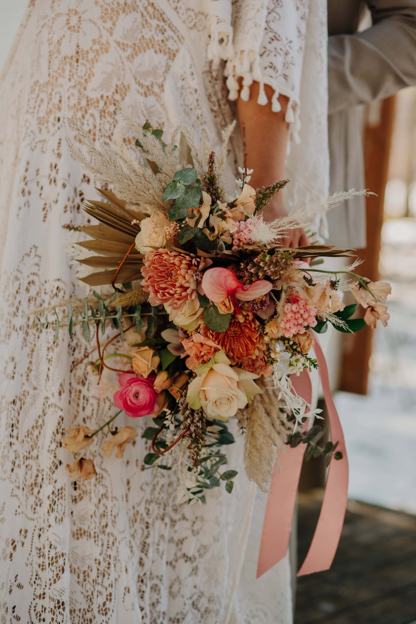 bride's bouquet with pink flowers and grasses at this Lake Easton winter elopement