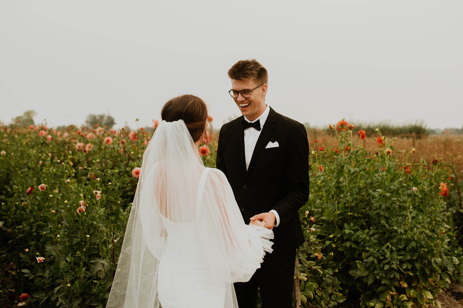 Groom smiling at bride during Oregon flower farm first look