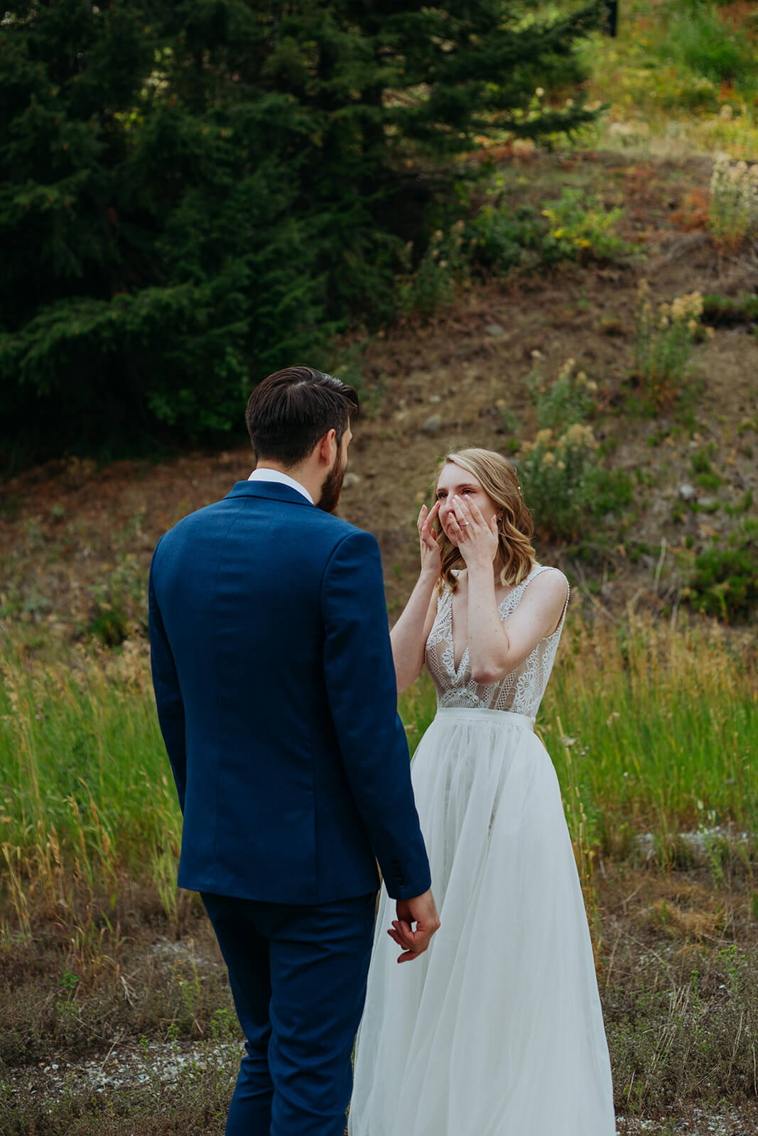 Bride gets emotional during first look at ski lodge wedding