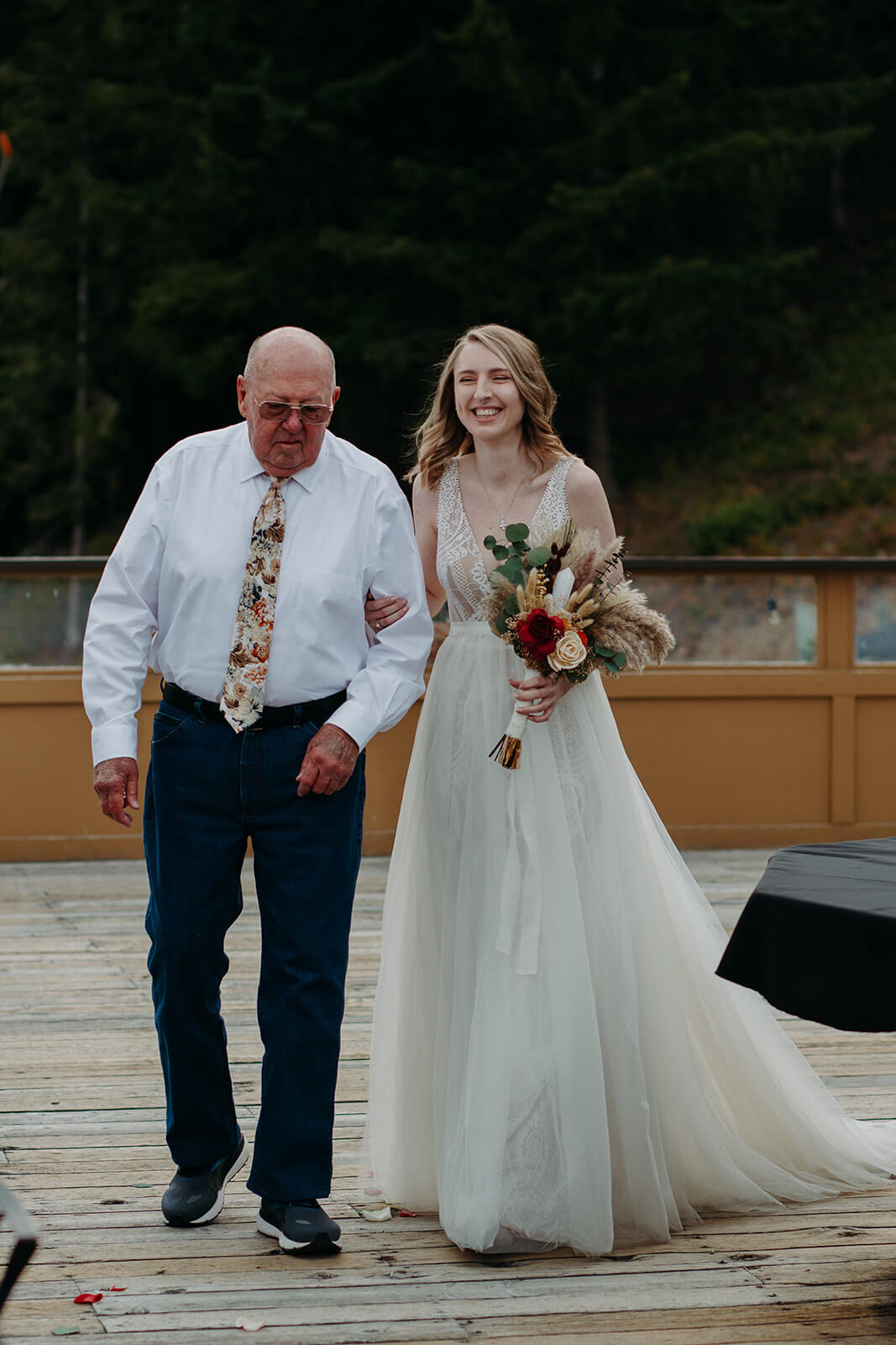 Bride and father walking down the aisle at ski lodge wedding