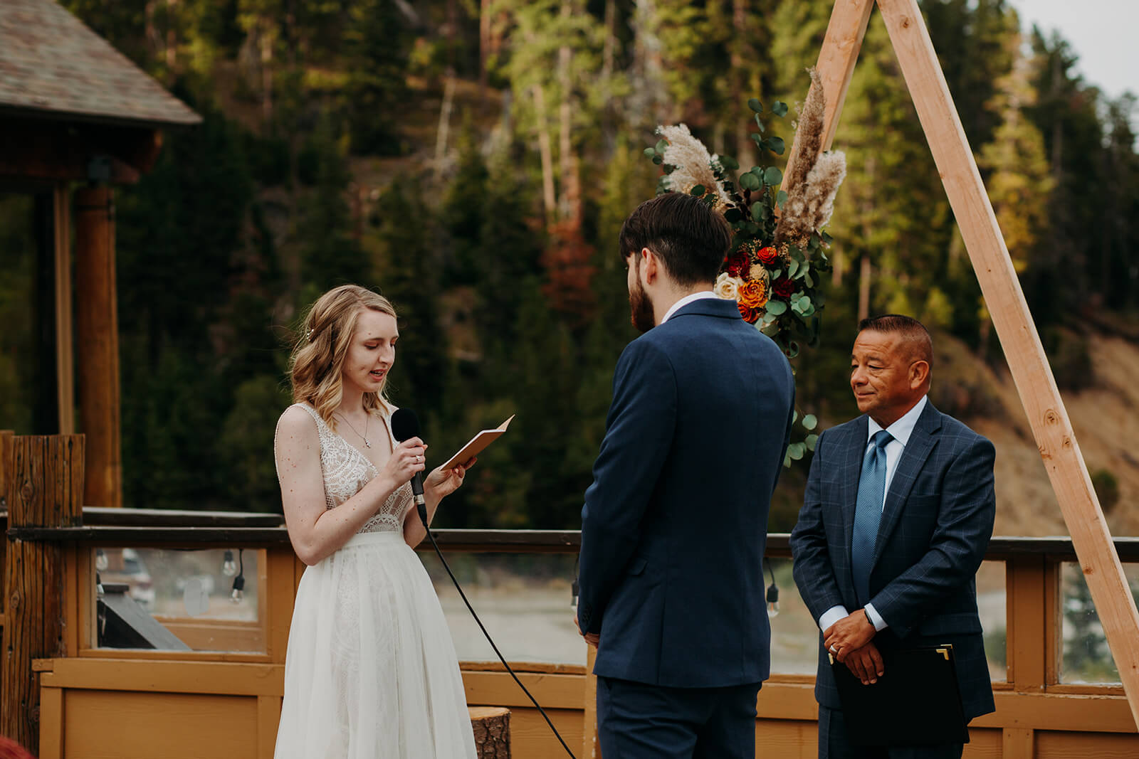 Bride reads vows at outdoor wedding ceremony at Mission Ridge Ski Resort