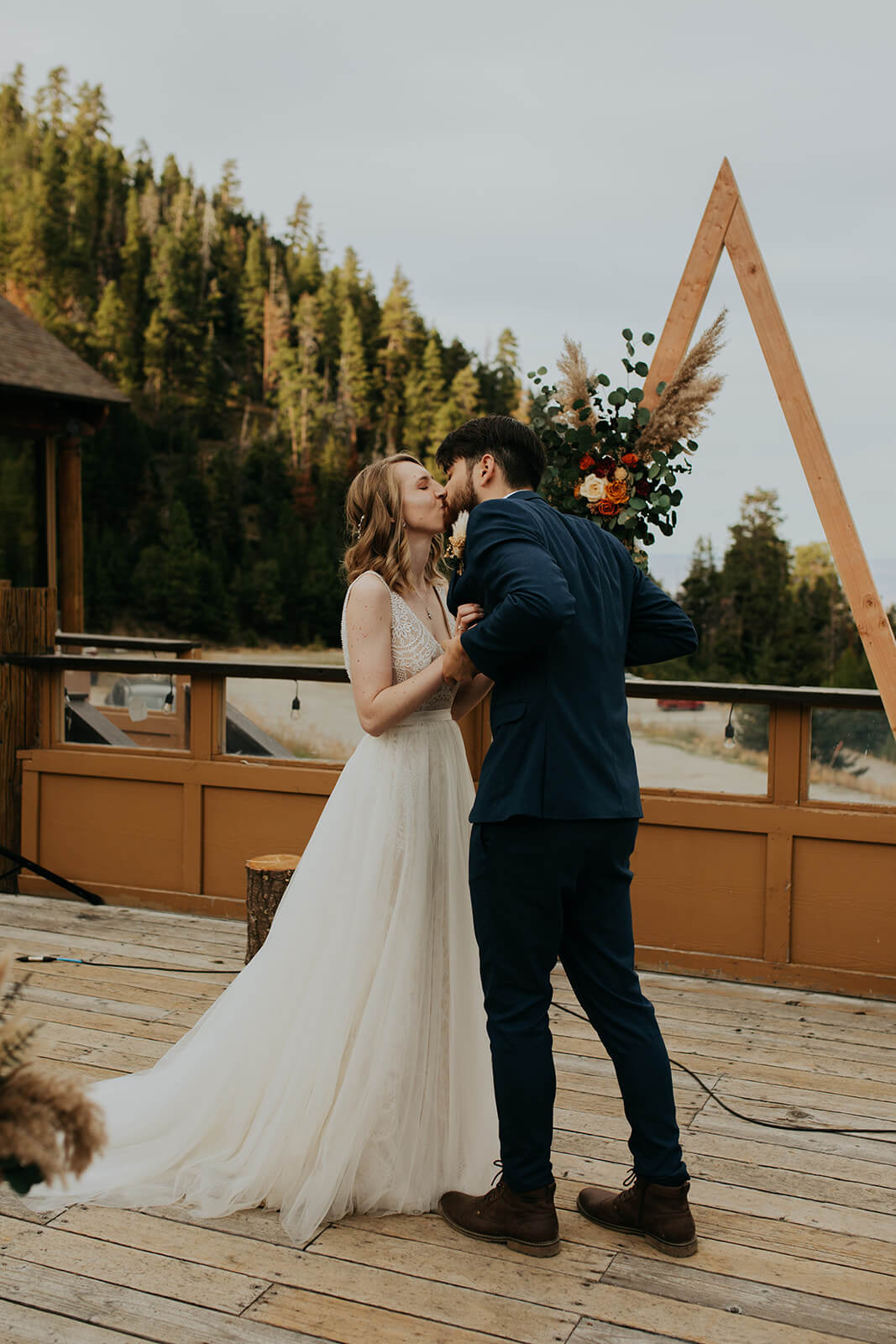 Bride and groom kiss at outdoor wedding ceremony at Mission Ridge Ski Resort