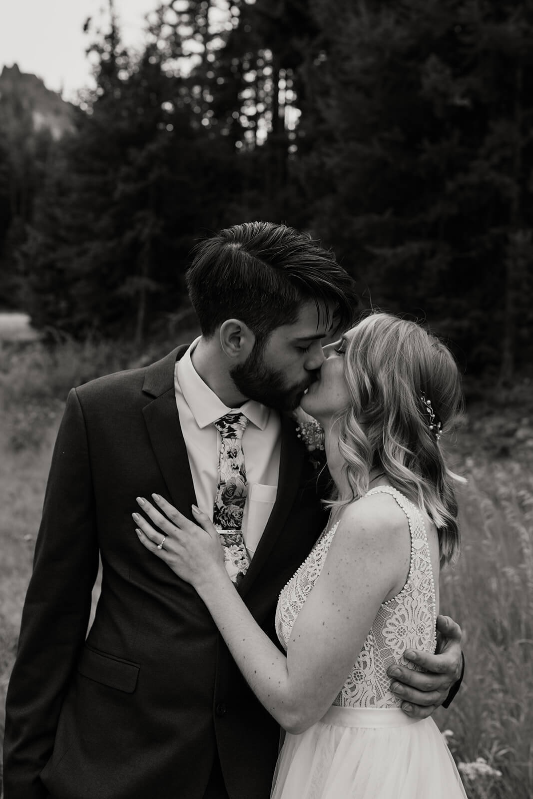 Bride and groom kiss during first look at ski lodge wedding