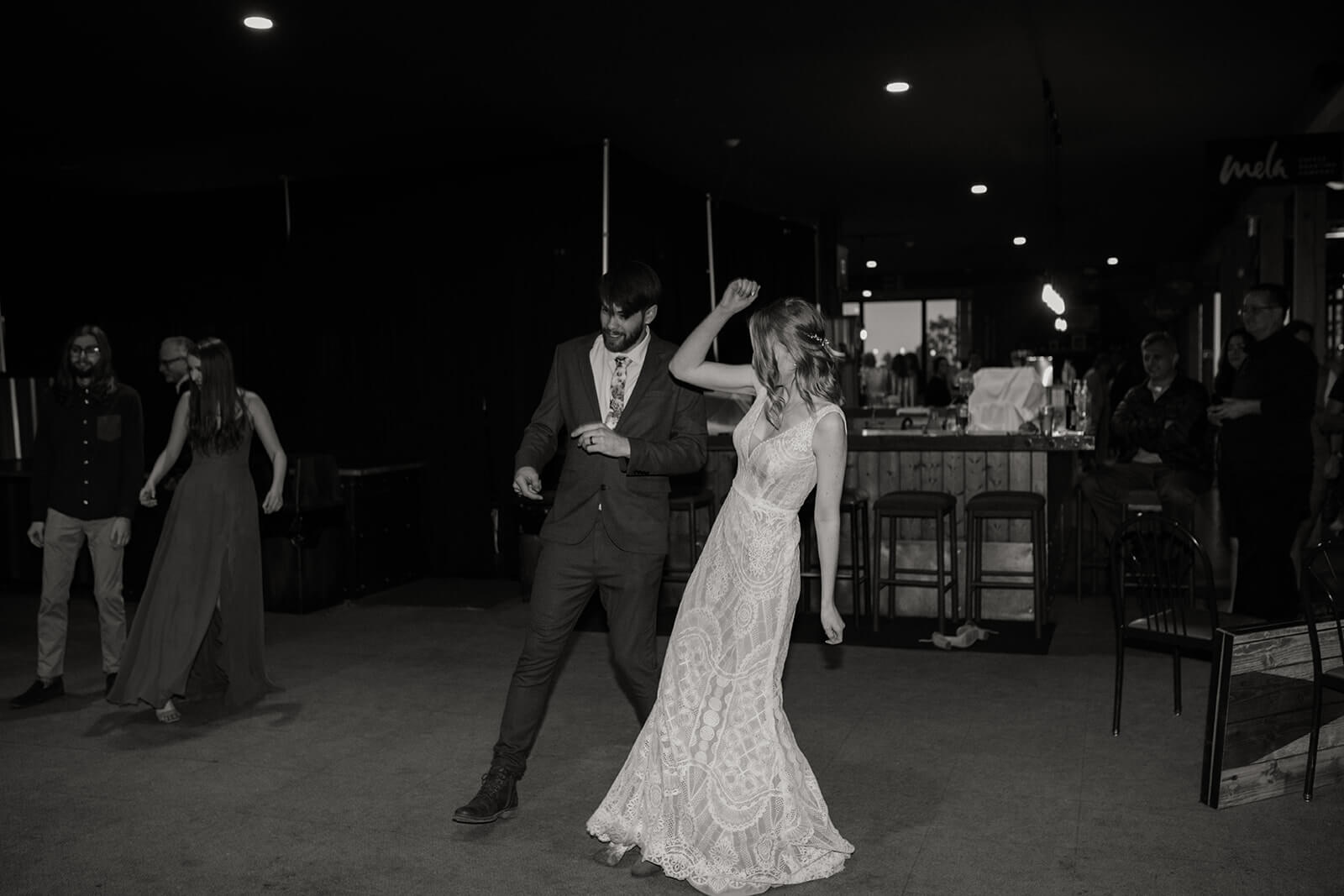 Bride and groom dance at ski wedding reception