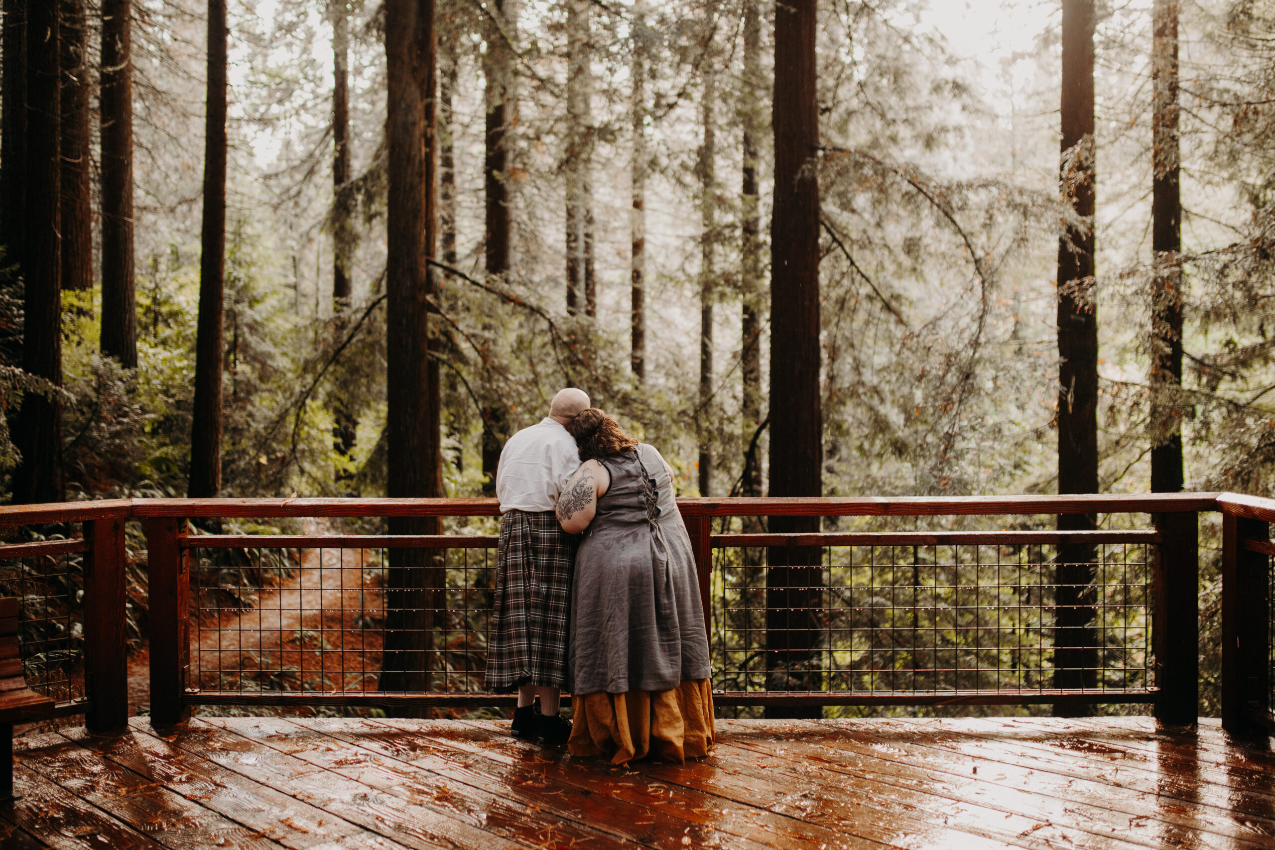 man and woman stand side by side on redwood observatory deck at hoyt arboretum