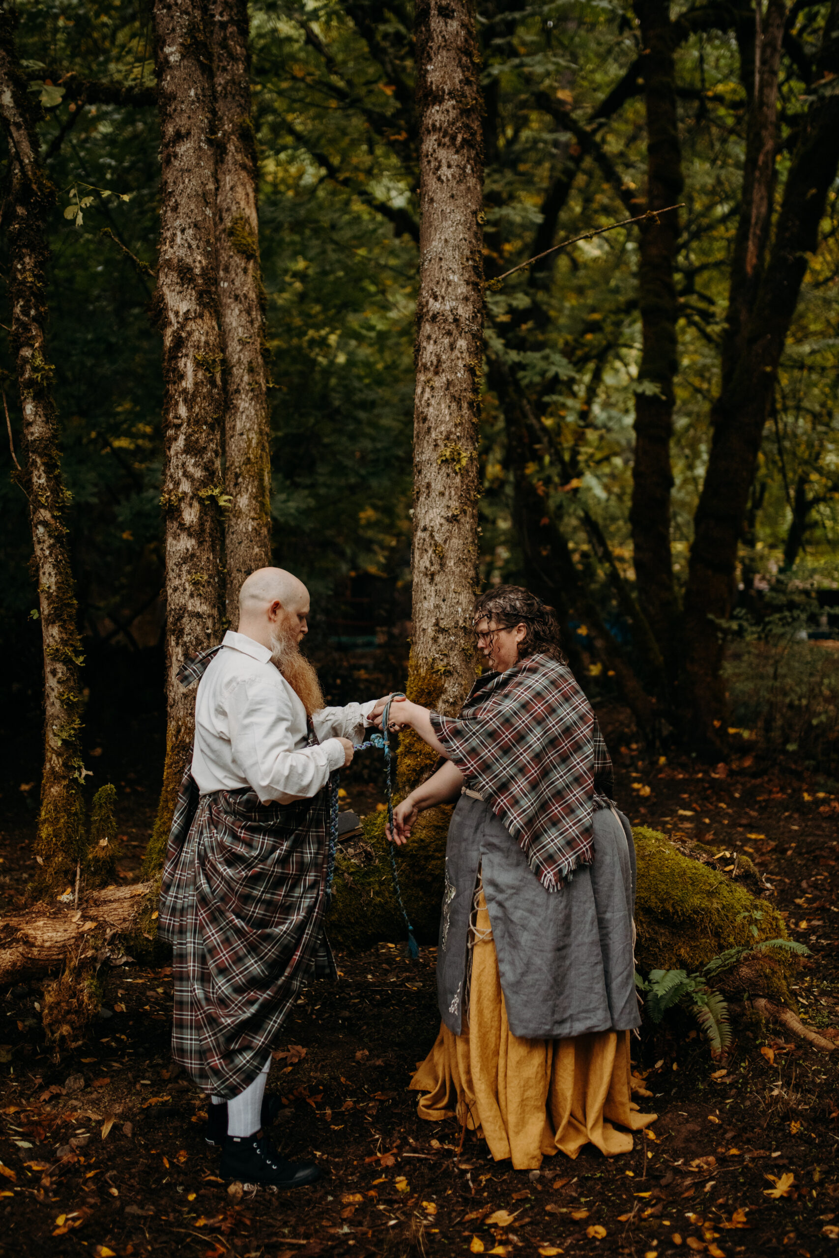 man and woman tie knot in forest
