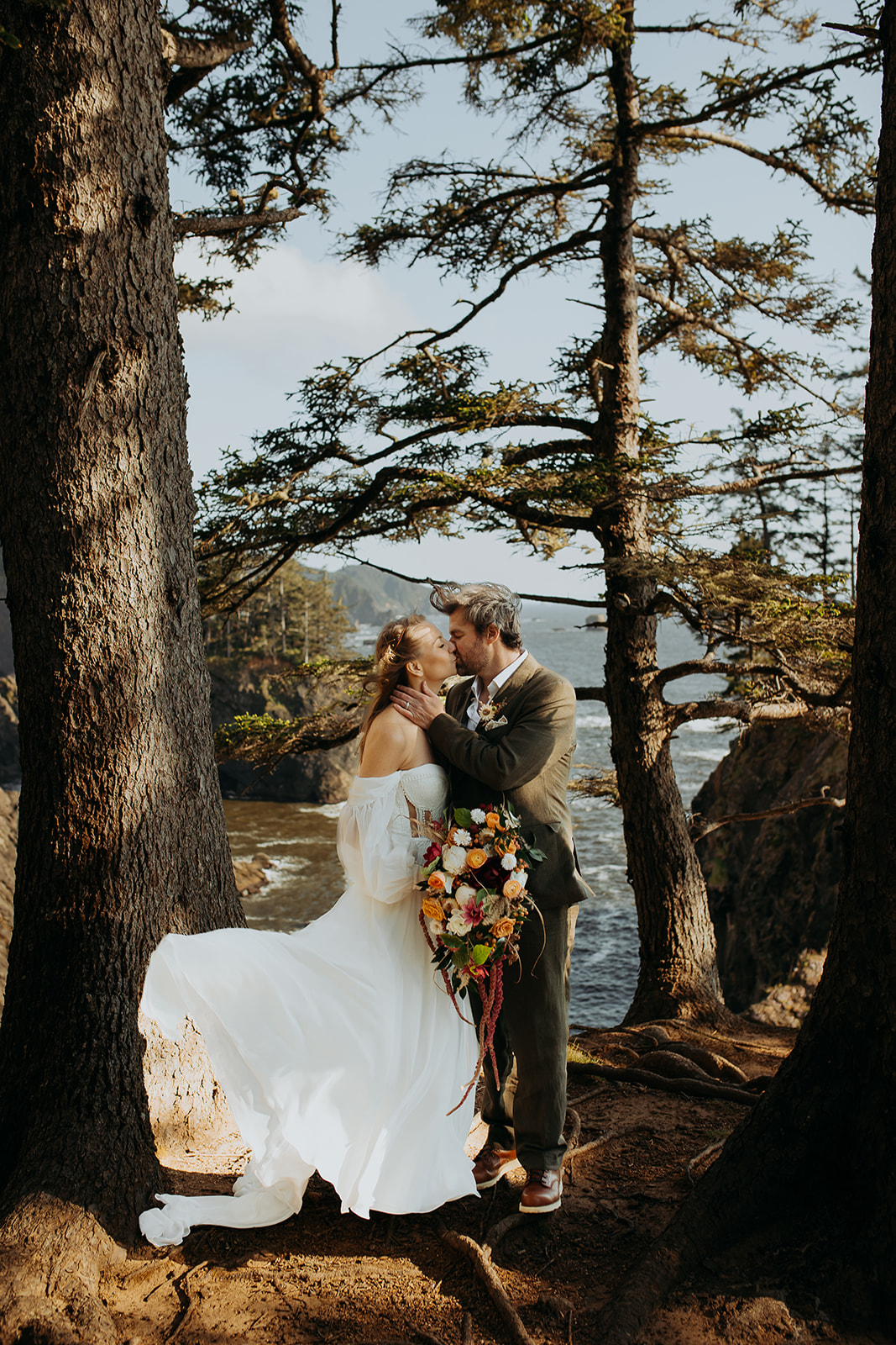 Bride and groom kiss for this Brookings, Oregon elopement at the Samuel H. Boardman scenic corridor overlook.